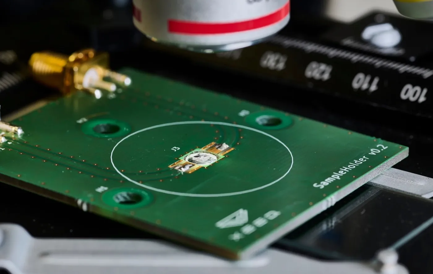 A diamond sample on a circuit board beneath a microscope